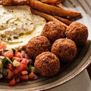 Close-up of Traditional falafel balls with salad and hummus on a