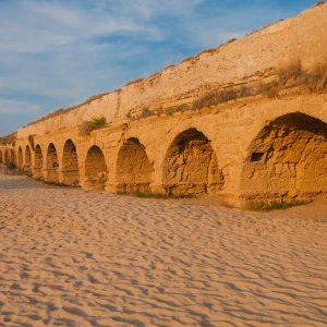 Ancient Roman aqueduct at sunset